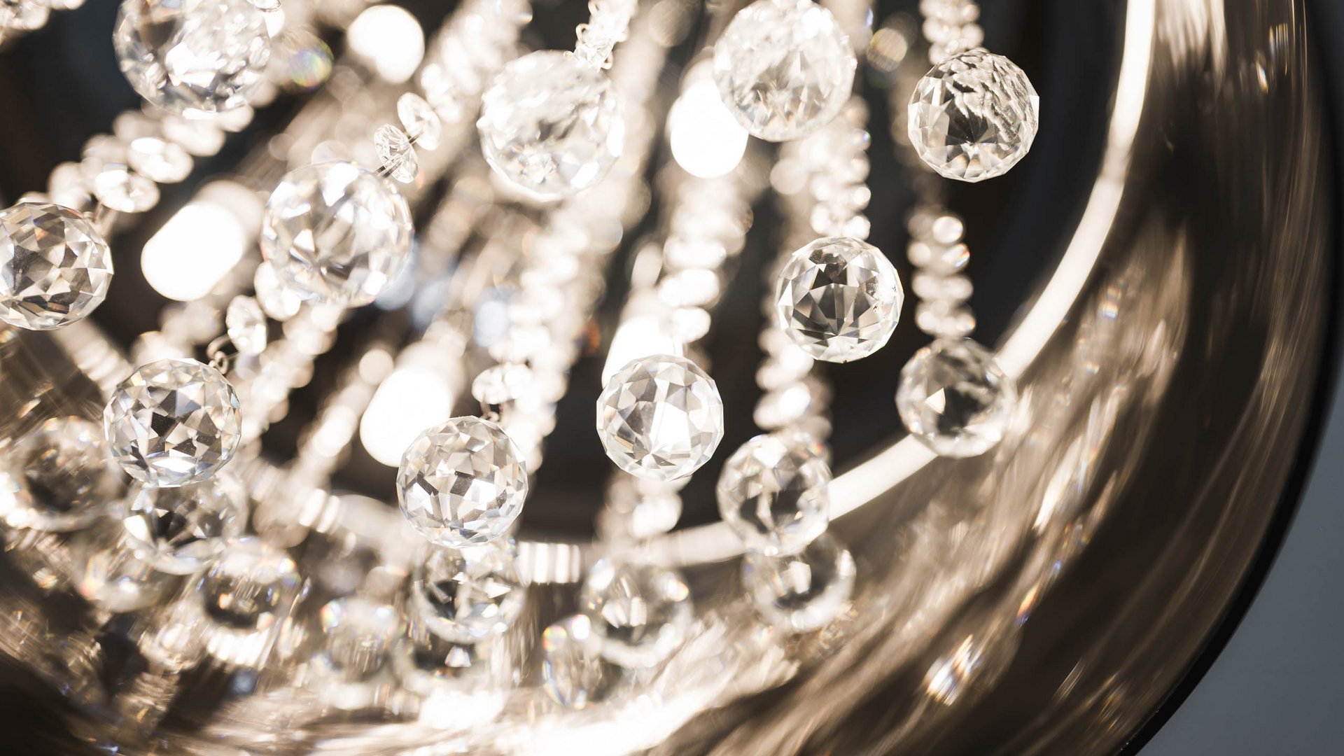 Close-up of hanging crystal chandelier pieces reflecting light