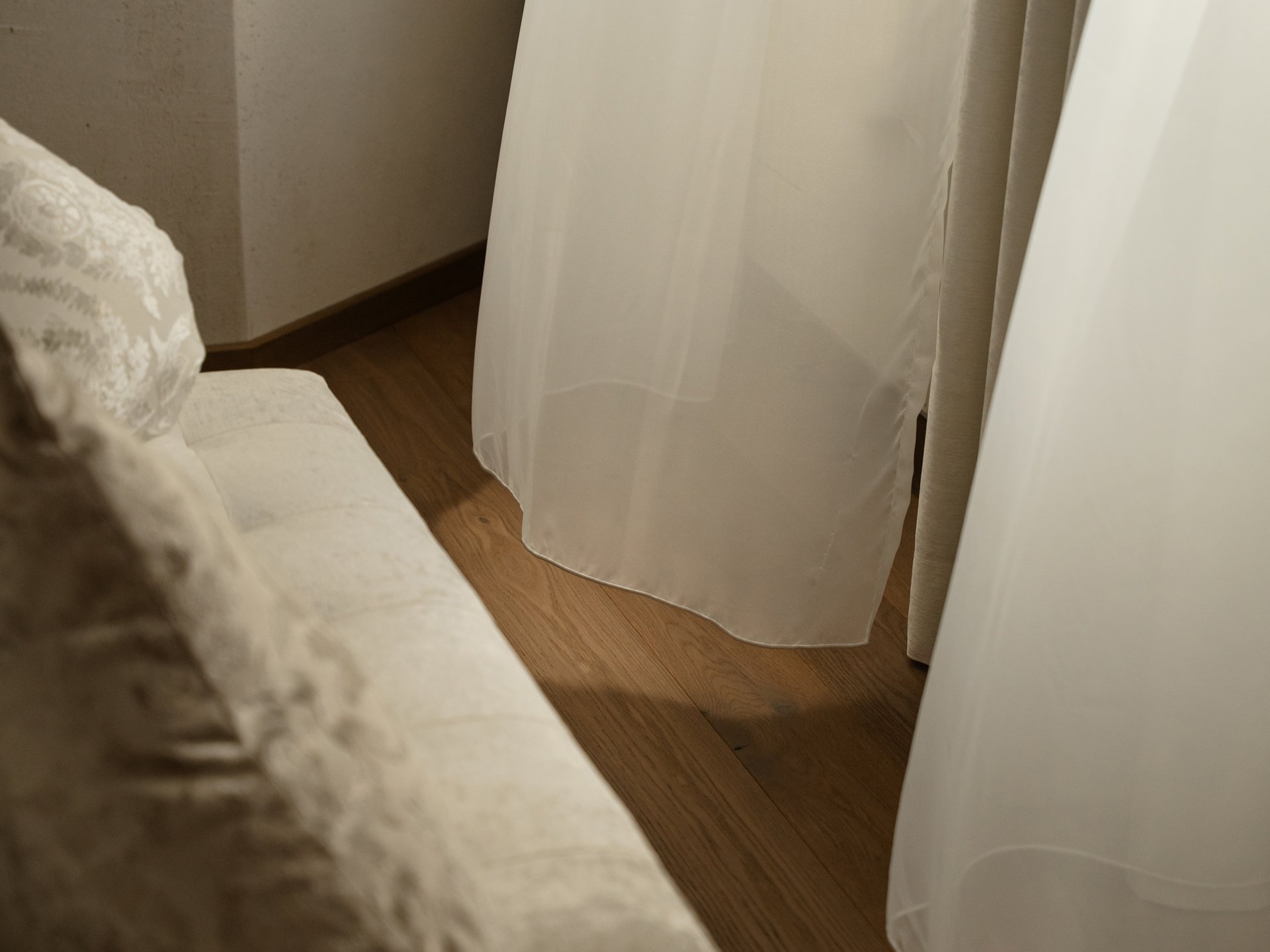 Feel-good holiday at our 5-star hotel in Serfaus Light sofa with cushions next to a window with white curtains