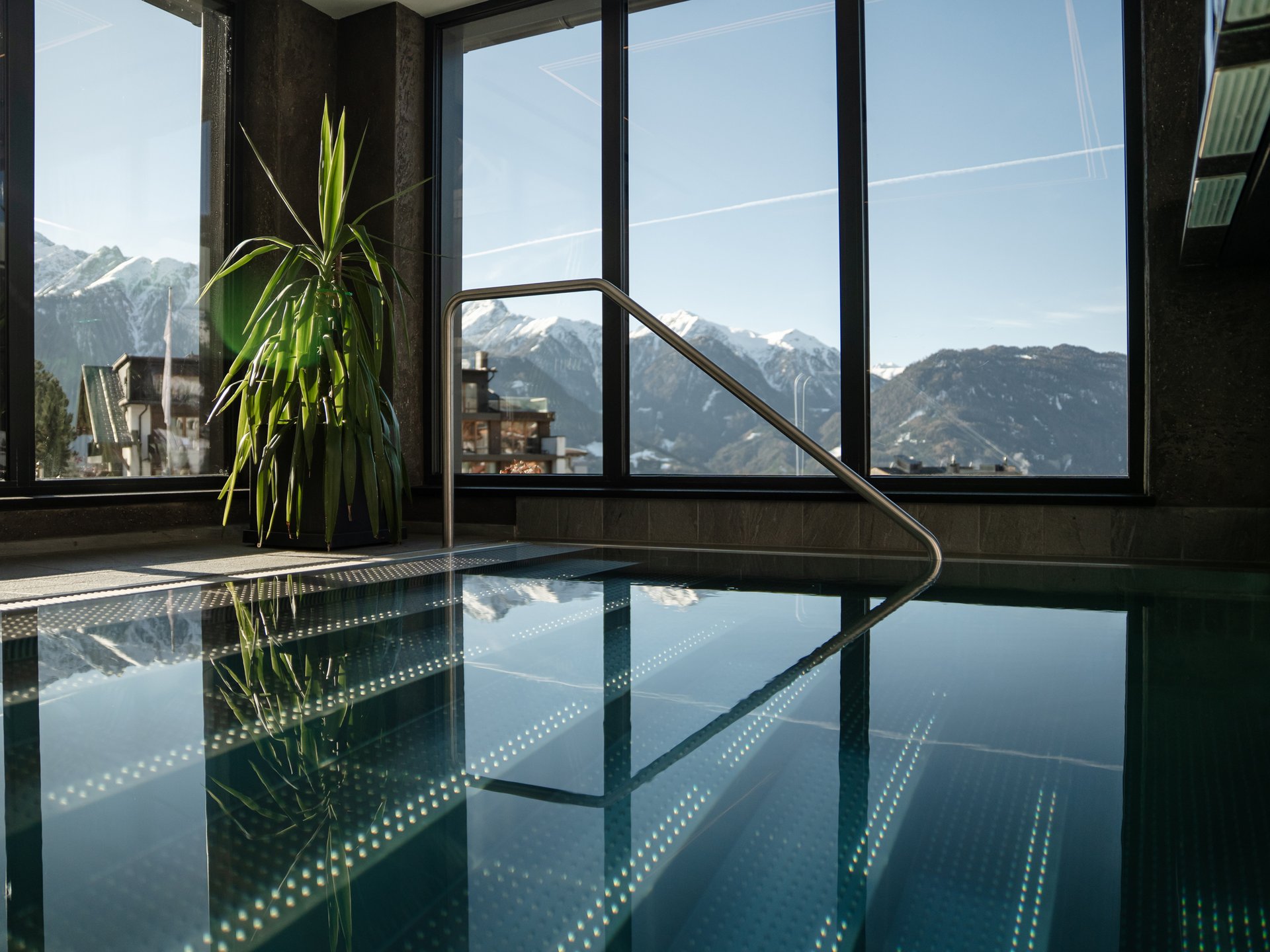 Innenpool mit Panoramafenstern und Blick auf schneebedeckte Berge