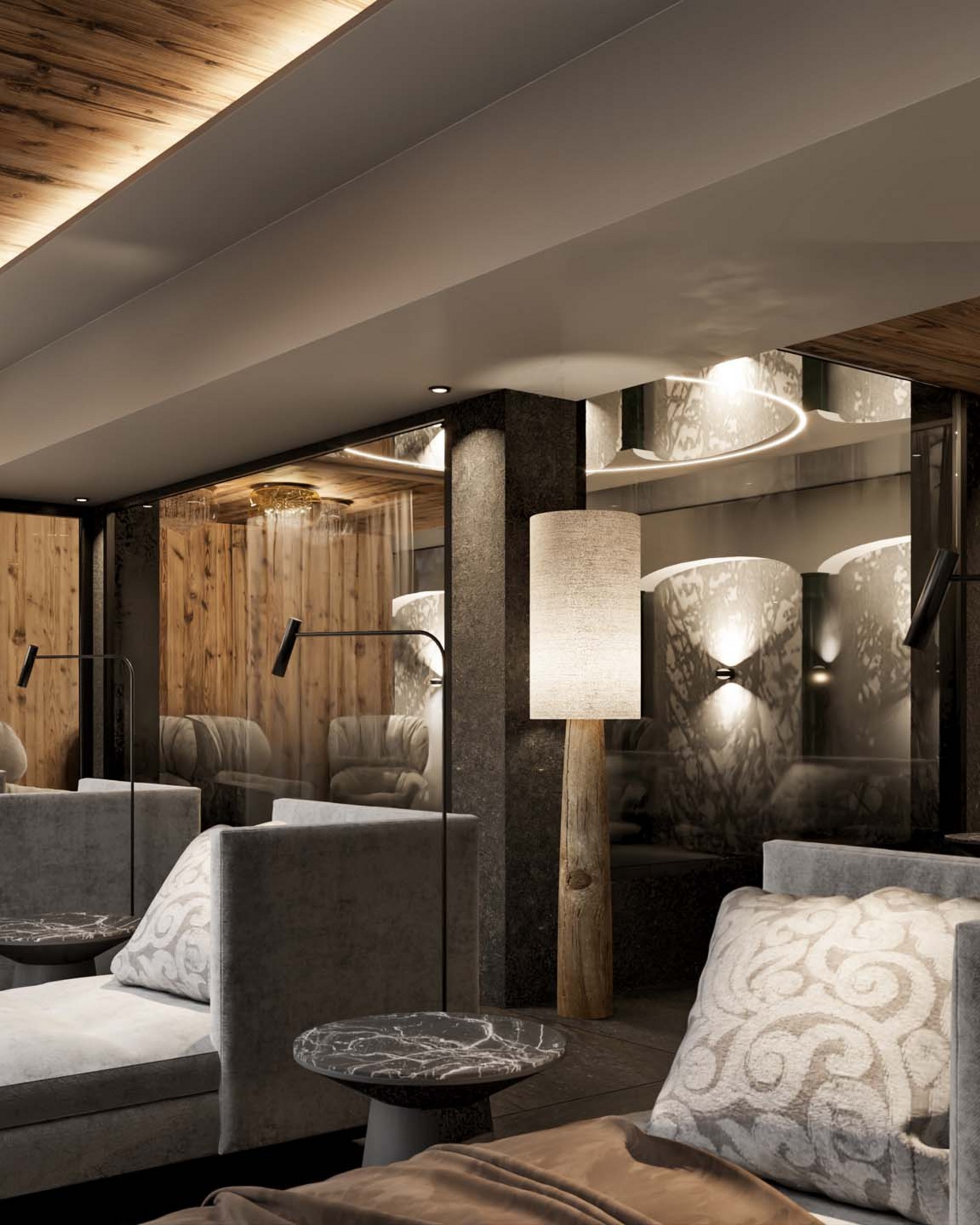 Modern cozy lounge area with gray chaise lounges, soft lighting, and wood accents