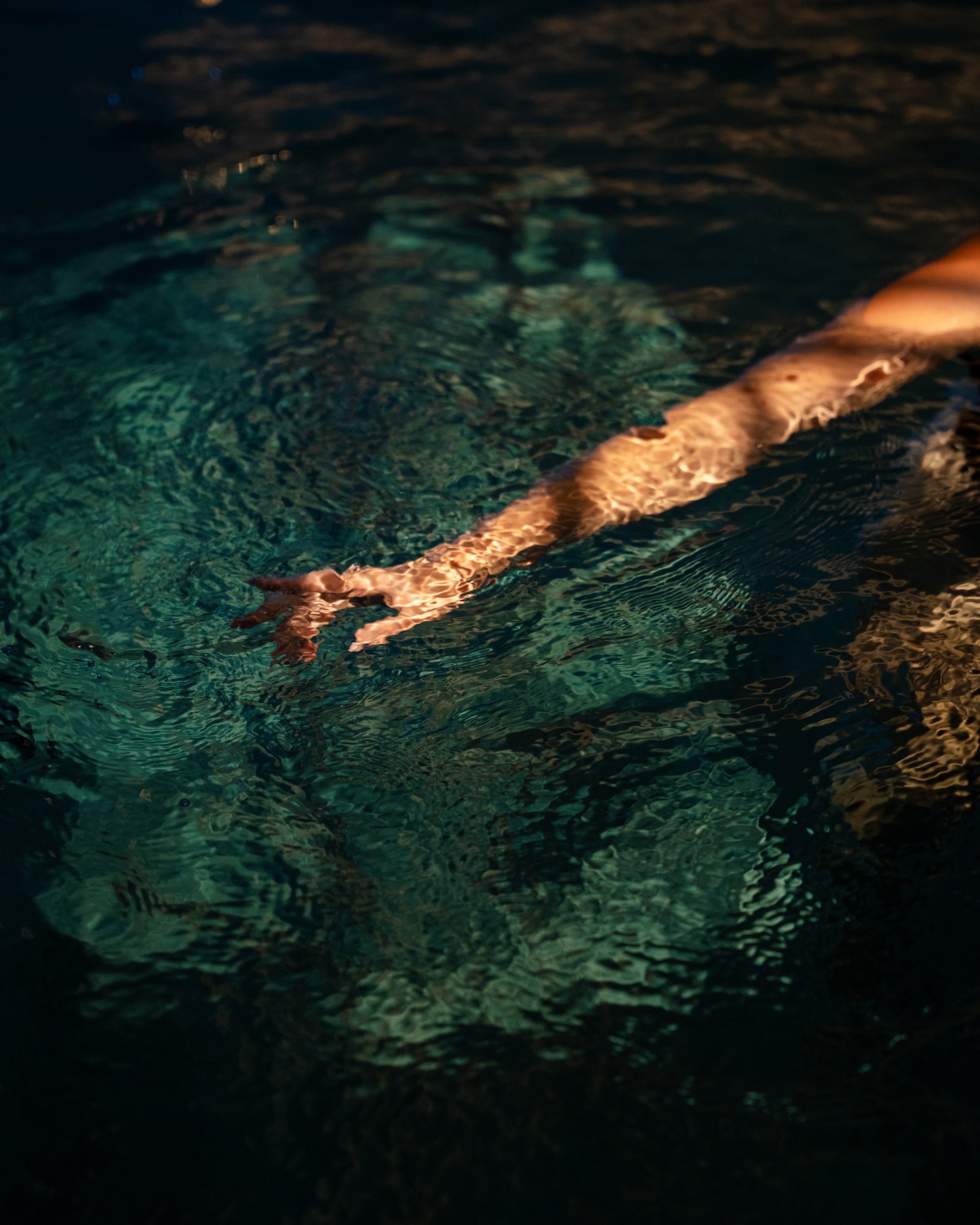 Bathing bliss at our hotel with pool in Serfaus Outstretched arm underwater with light reflections