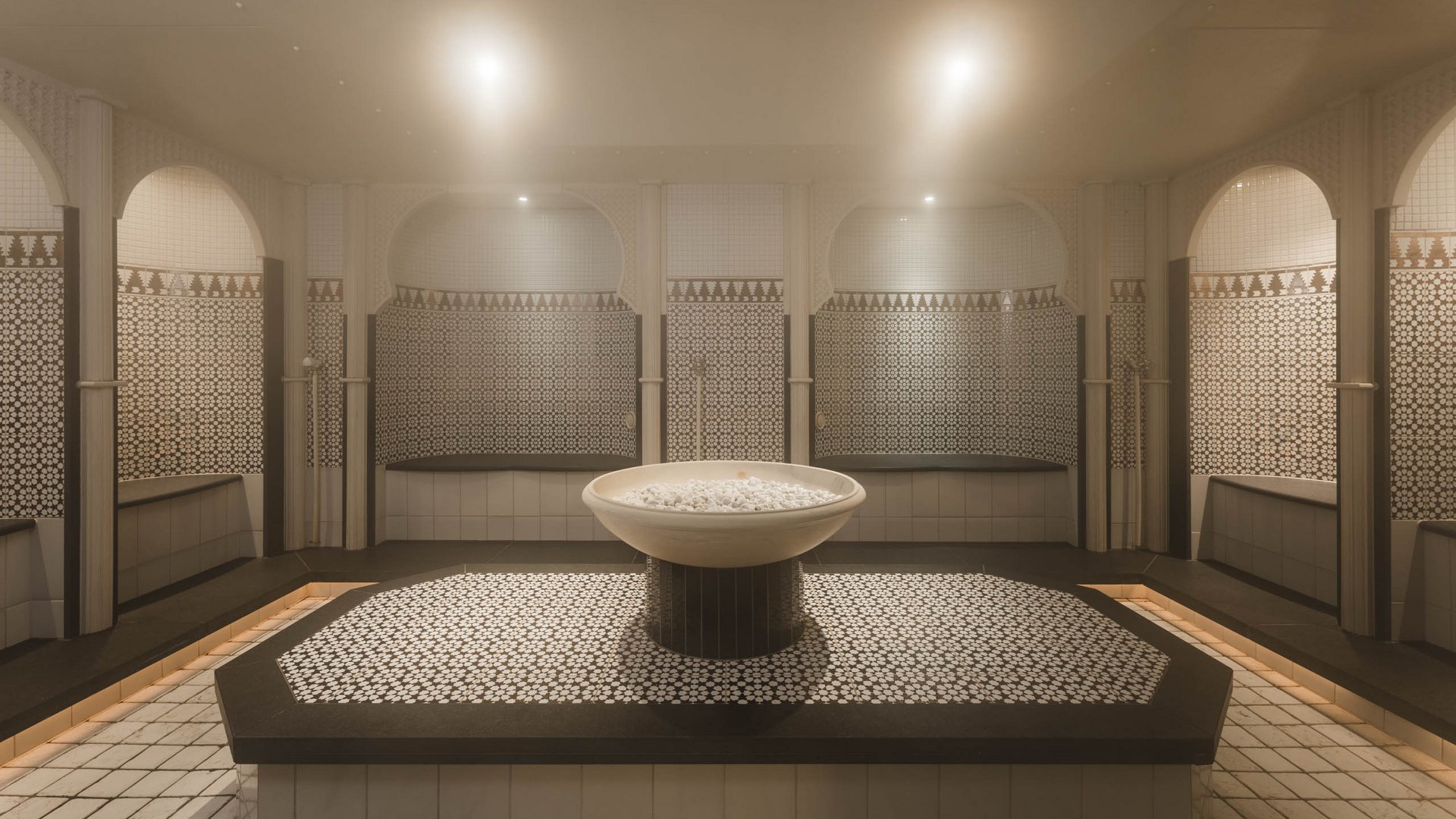 Traditional hamam with soap bowl and mosaic tiles