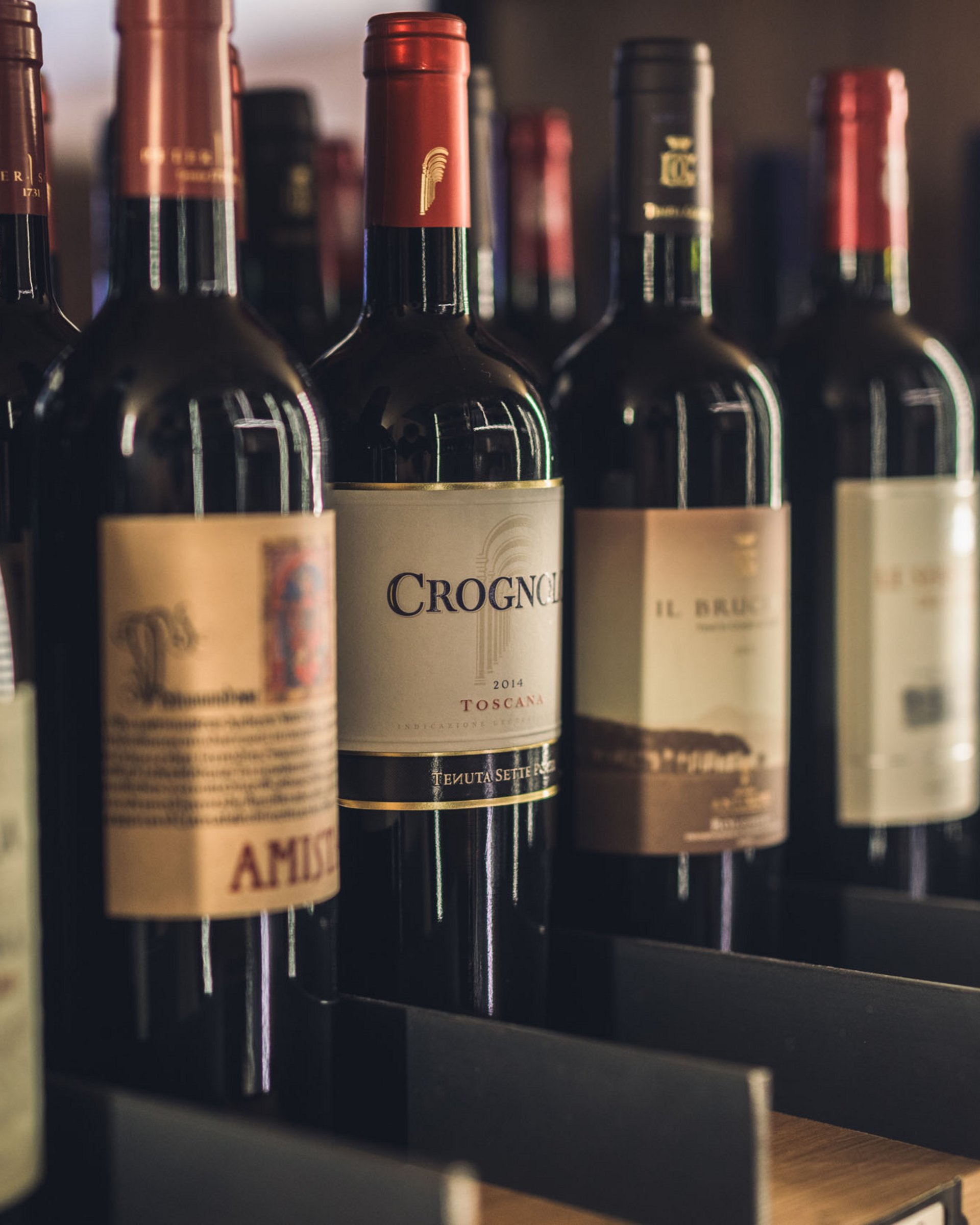 Several bottles of red wine in a wooden wine rack