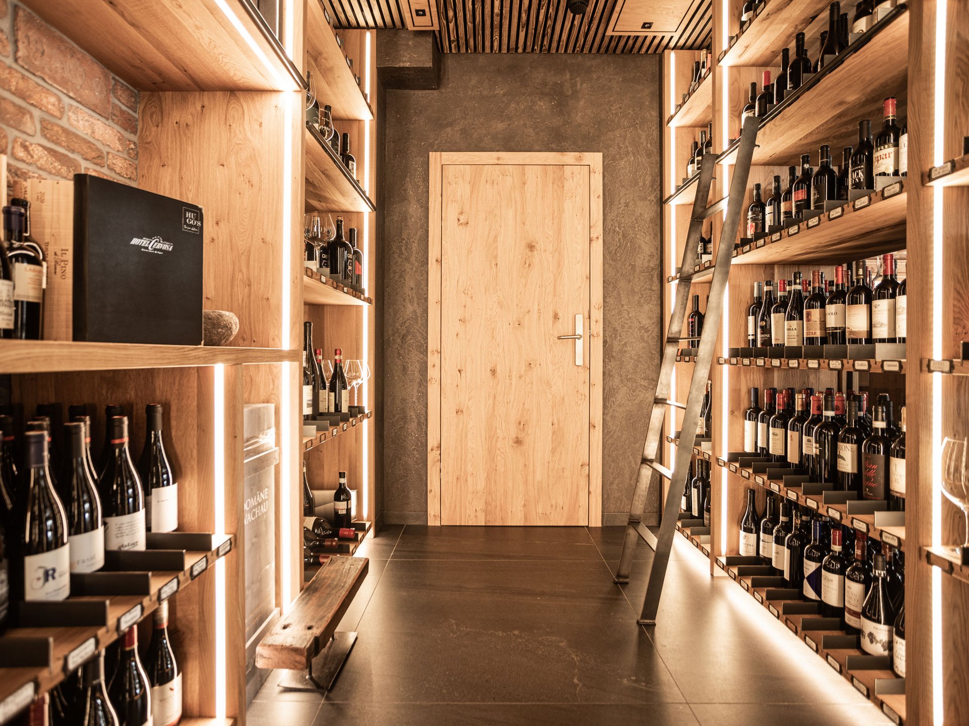 Wine cellar with wooden shelves and illuminated bottles