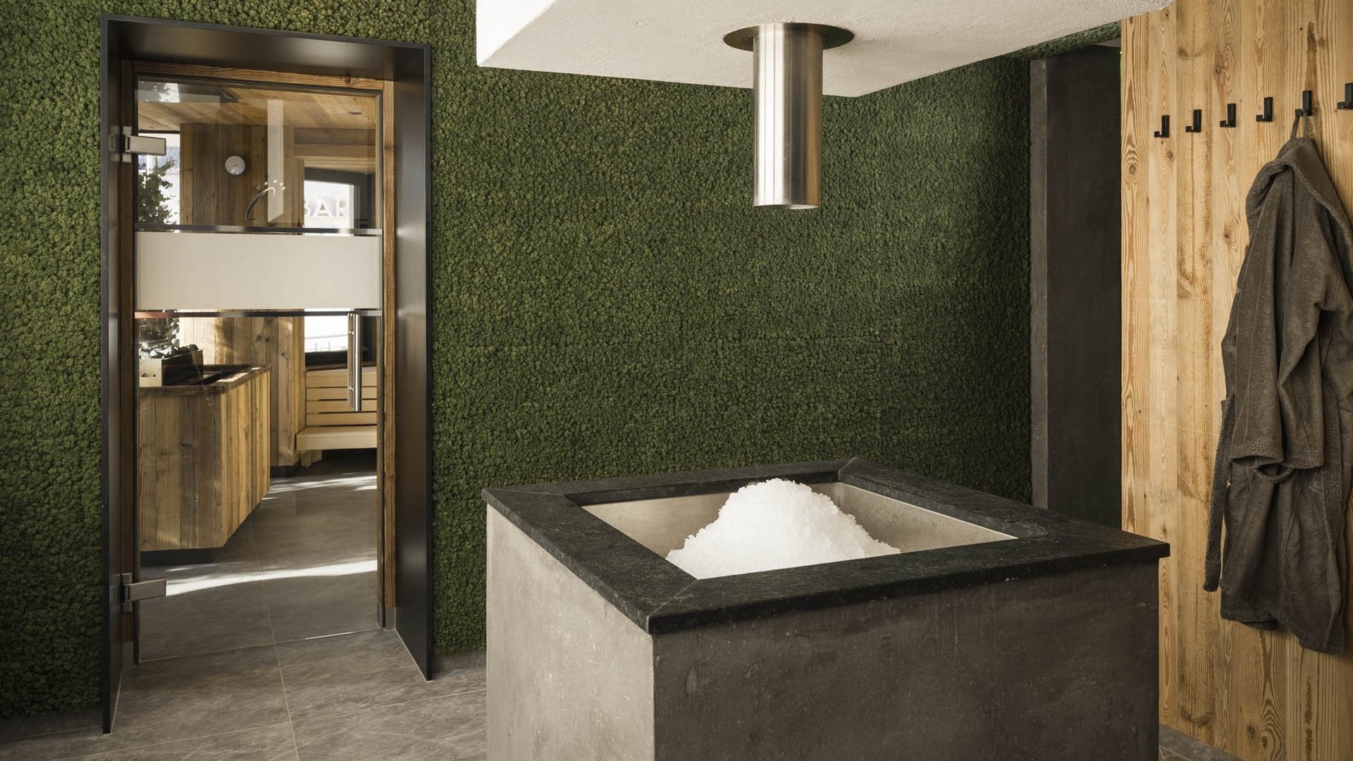 Modern sauna room with ice fountain and wooden walls