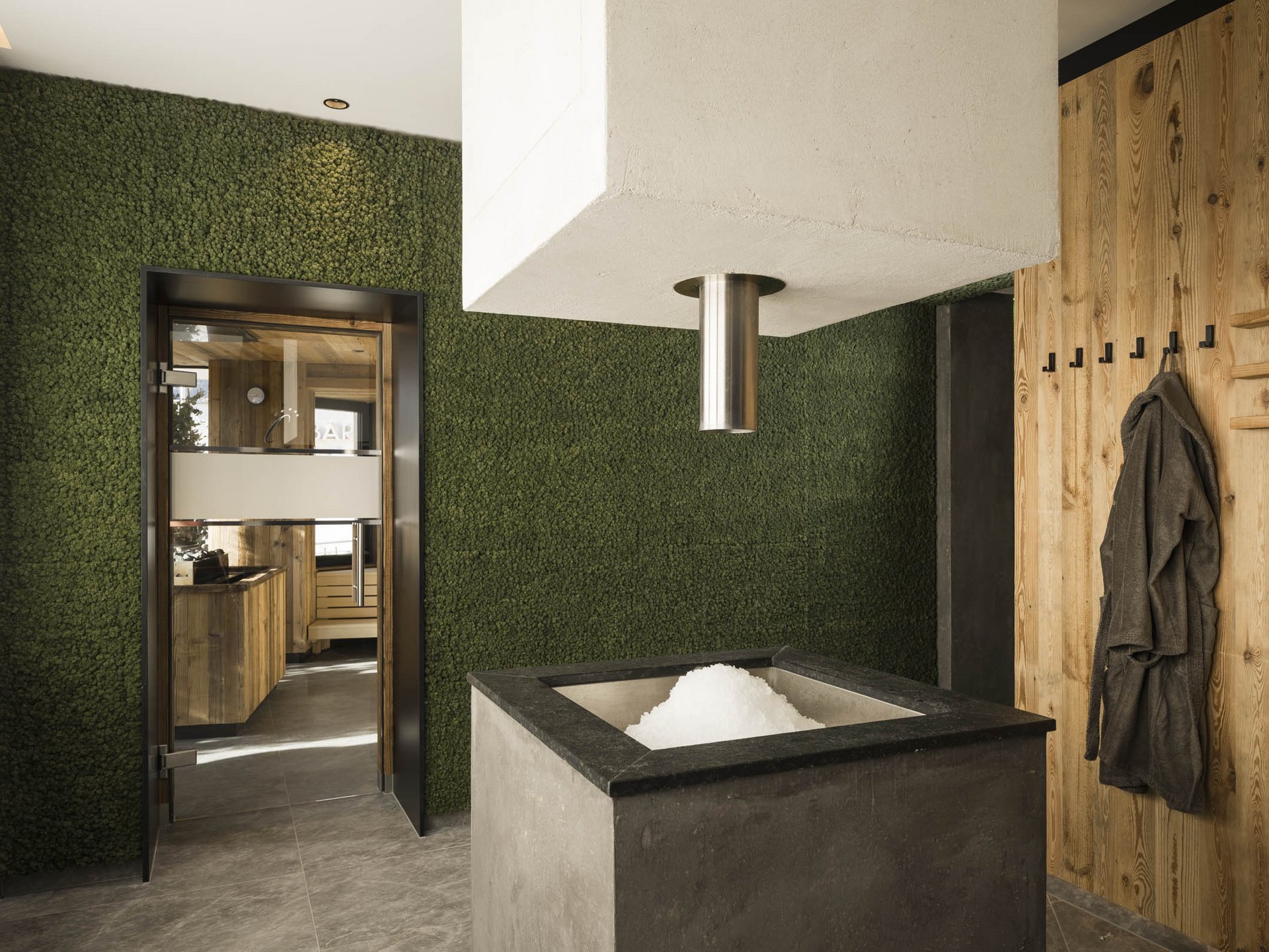 Modern sauna room with ice fountain and wooden walls