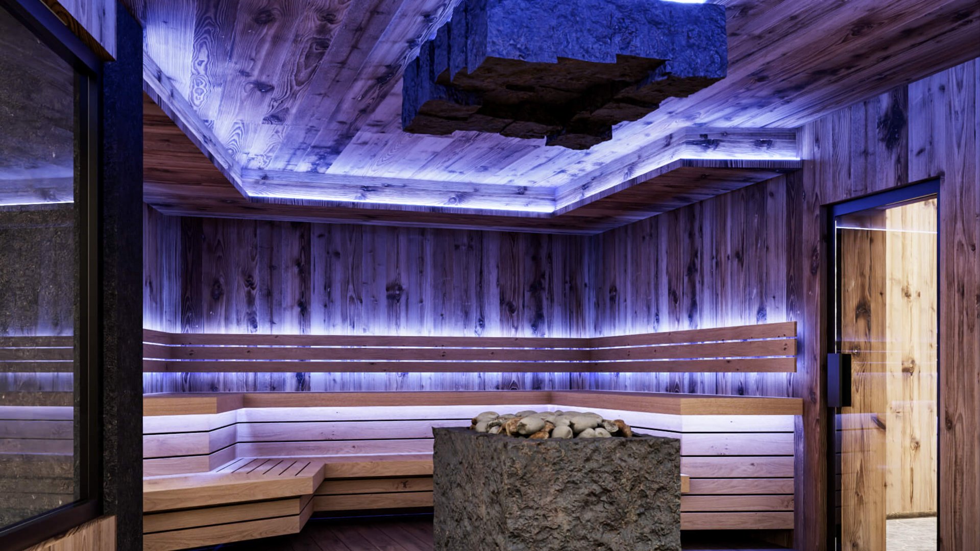 Moderne Sauna mit Holzverkleidung, Steinofen und indirekter blauer Beleuchtung