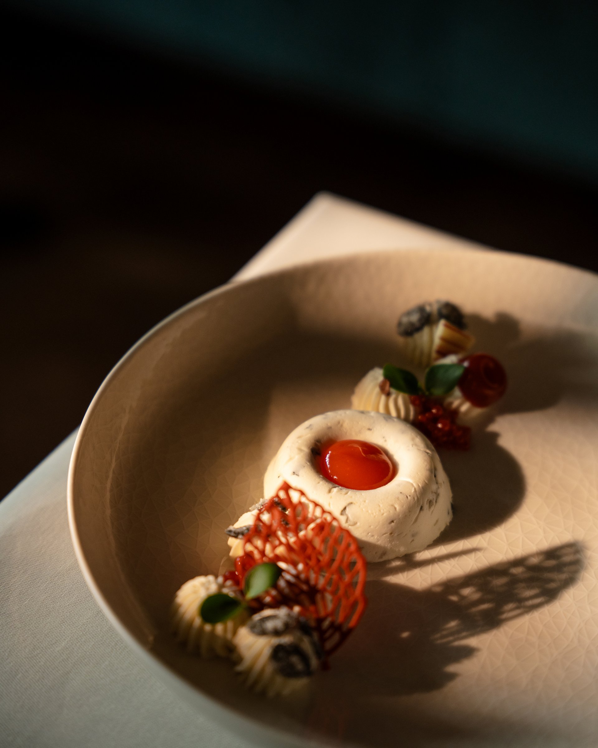 Feel-good holiday at our 5-star hotel in Serfaus Artfully plated dessert with red sauce and garnishes on beige plate