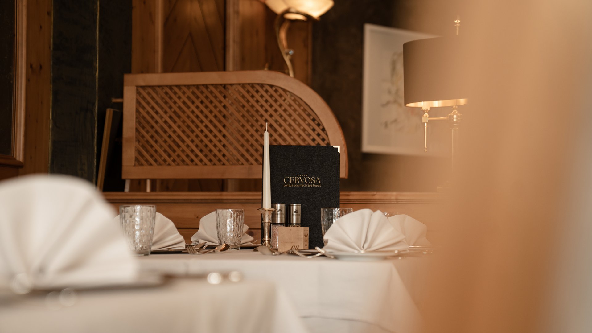 Elegant restaurant table setting with candle at Cervosa Serfaus Resort